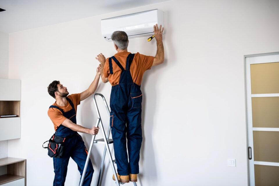 HVAC technicians installing ductless mini-split air conditioning unit in Algonquin, IL