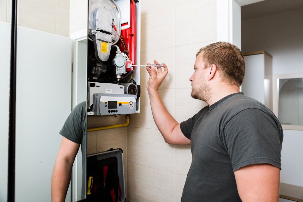 HVAC technician performing furnace maintenance inspection